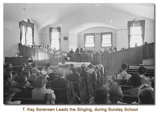 Thomas Kay Sorensen leads the singing during Sunday school