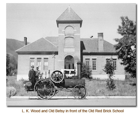 L. K. Wood and Old Betsy in front of the 1899 red brick school.