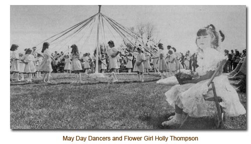Holly Thompson, Flower Girl watches the May Day Dancers.